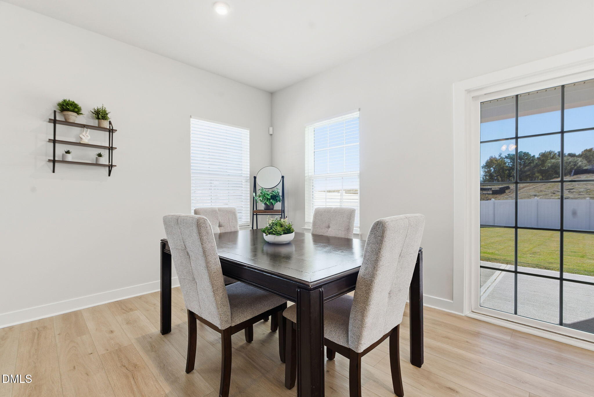 508 Freedom Trail Drive Willow Spring, NC 27592 - Photo 21 of 65 a view of a dining room with furniture wooden floor and a potted plant