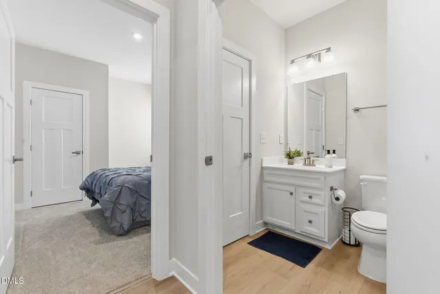 an empty room with windows and chandelier fan