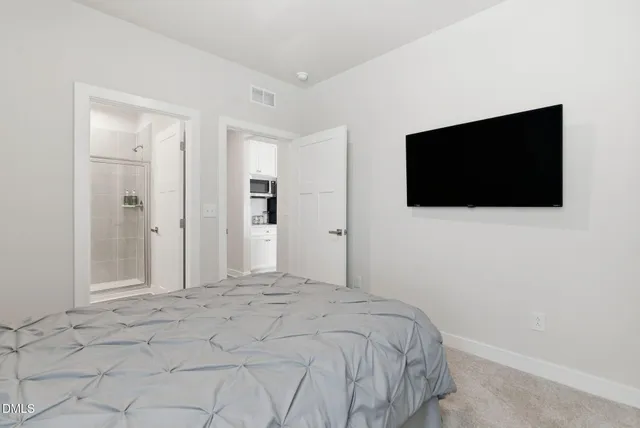 a spacious bathroom with a double vanity sink a mirror and a shower