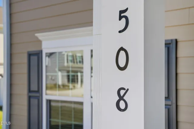 an empty room with wooden floor and window
