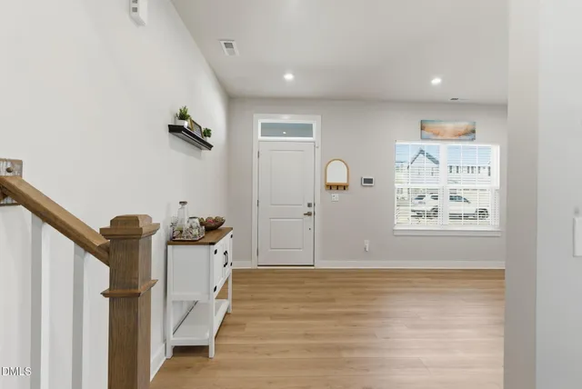 a view of entryway and hall with wooden floor