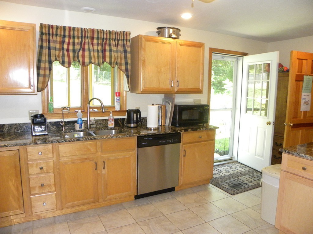 290 North Sturbridge Road Charlton, MA 01507 - Photo 20 of 30 a kitchen with stainless steel appliances granite countertop a stove and a refrigerator