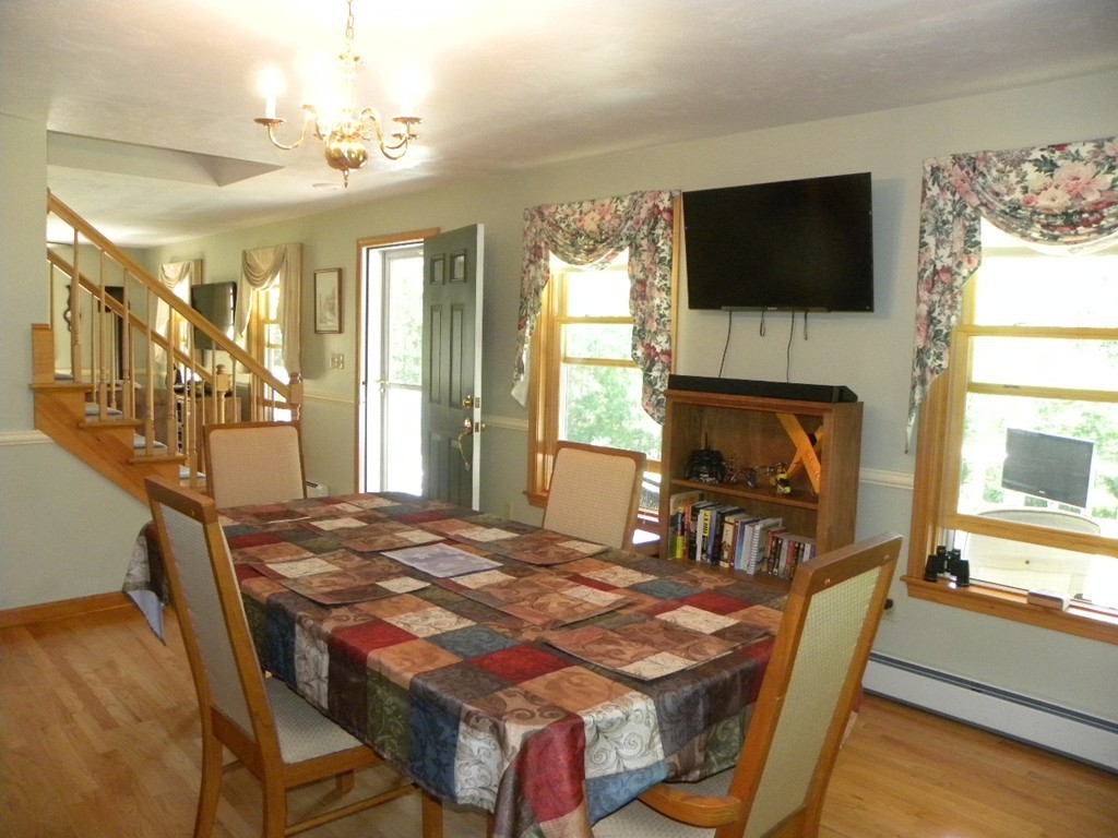 290 North Sturbridge Road Charlton, MA 01507 - Photo 8 of 30 a bedroom with a bed a flat screen tv and windows