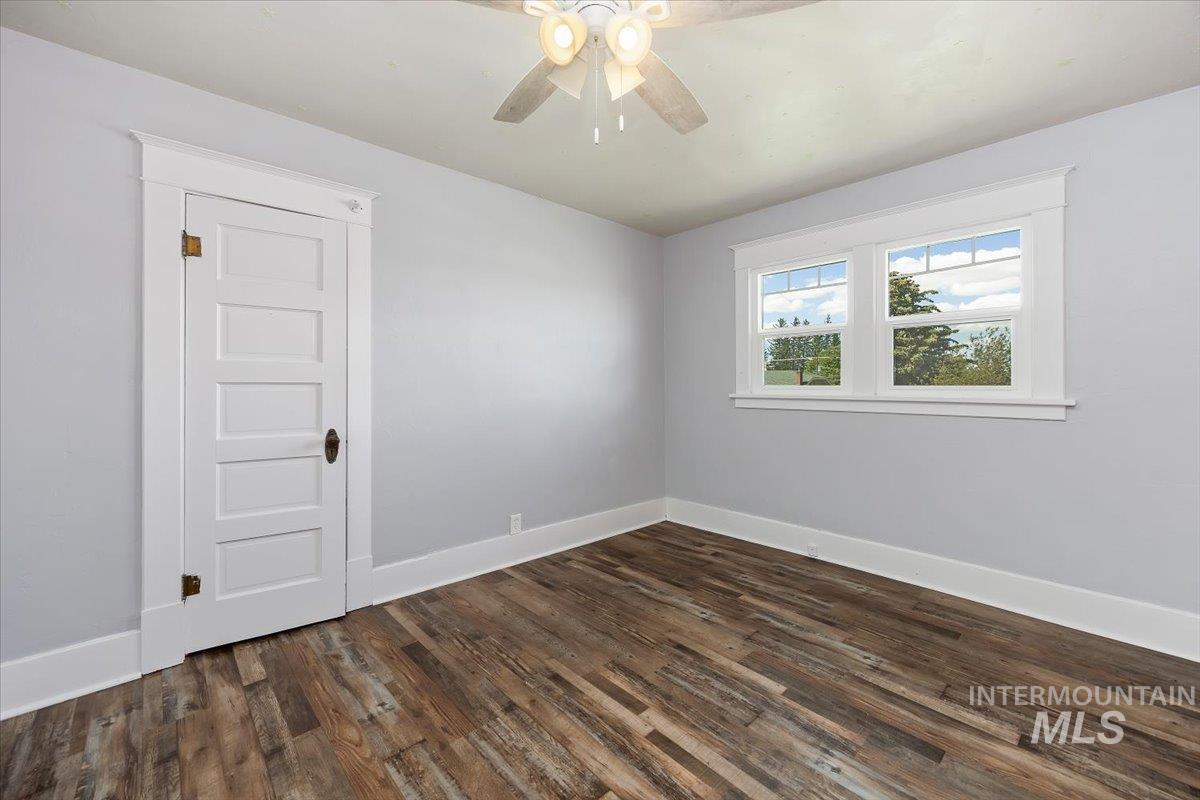 813 7th Street Rupert, ID 83350 - Photo 34 of 48 Room featuring wood-finish flooring, light gray wall paint, and white trim throughout