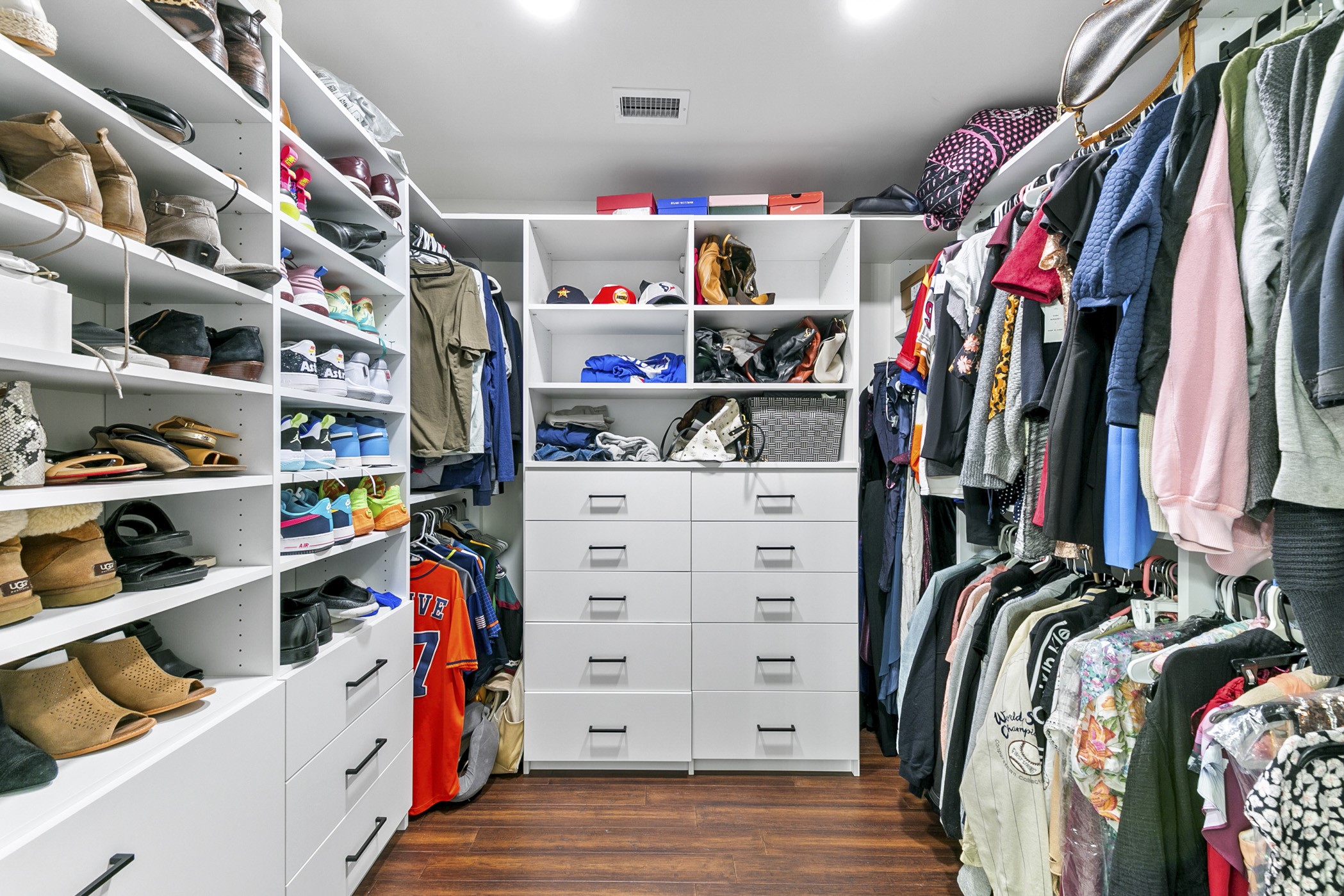 1609 Tabor Street Houston, TX 77009 - Photo 31 of 36 Step into the custom walk-in closet off the primary bedroom, offering tailored storage solutions and abundant space for easy organization.