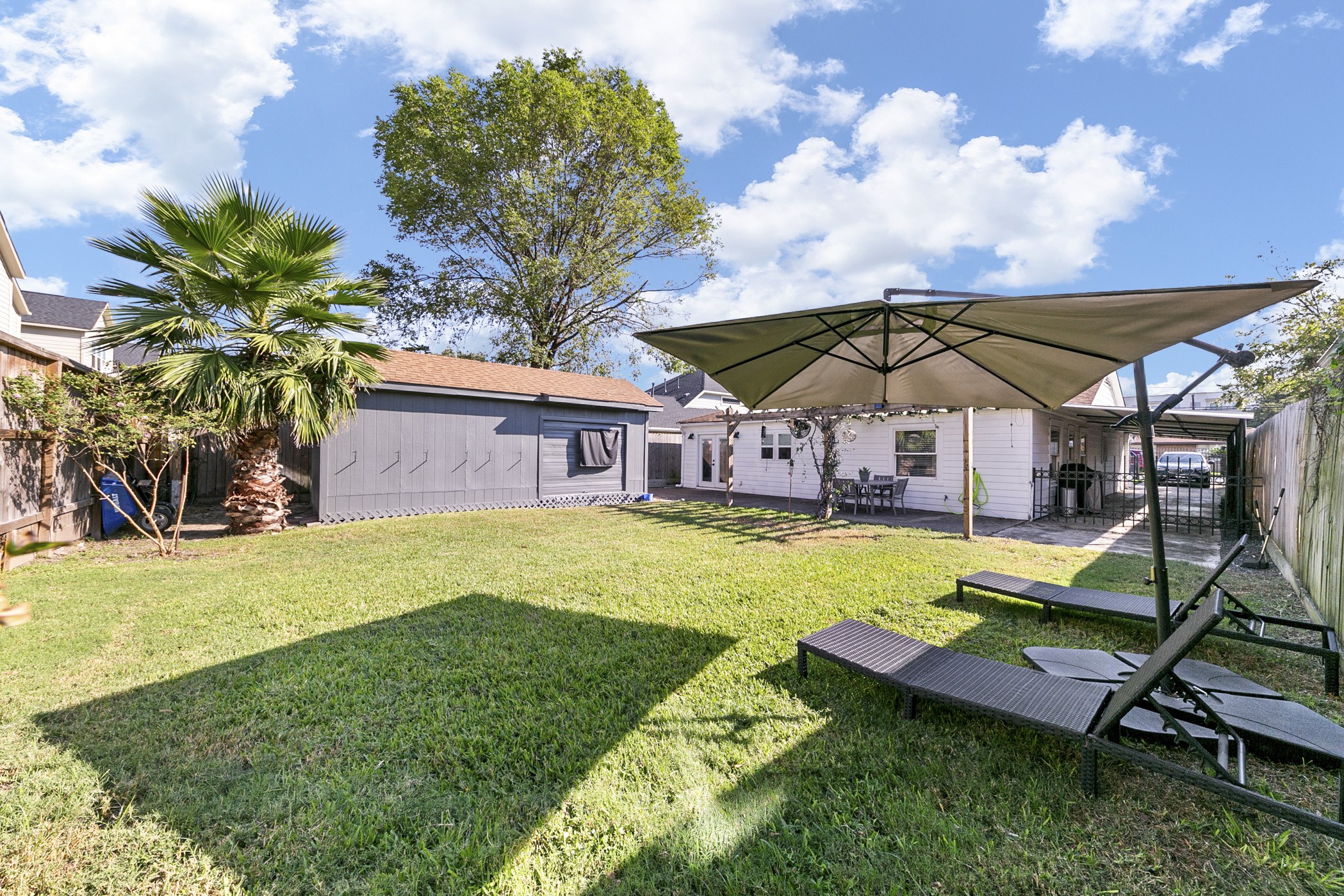 1609 Tabor Street Houston, TX 77009 - Photo 36 of 36 The lush backyard offers a serene escape, with vibrant greenery and ample space to unwind or enjoy outdoor activities.