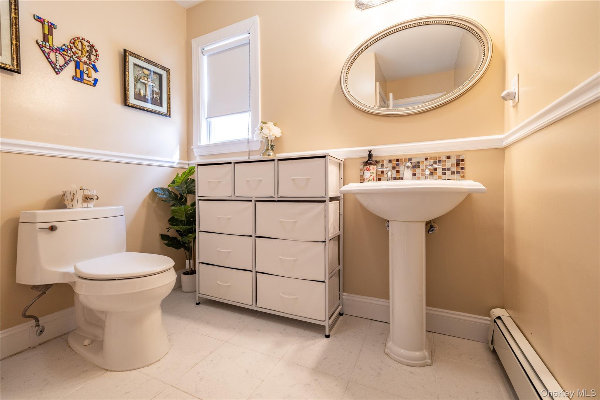 458 East Pine Street Long Beach, NY 11561 - Photo 3 of 26 a bathroom with a sink a mirror and a toilet