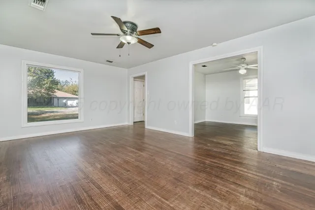 wooden floor in an empty room with a window