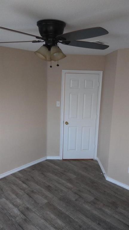 306 Packer Drive Fate, TX 75189 - Photo 11 of 15 a view of a small space with wooden floor and a ceiling fan
