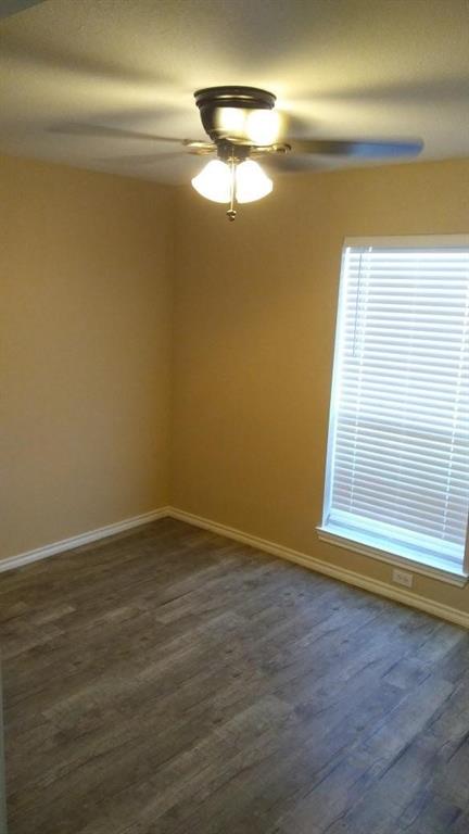 306 Packer Drive Fate, TX 75189 - Photo 13 of 15 a view of an empty room with wooden floor and a window