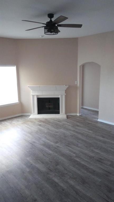 306 Packer Drive Fate, TX 75189 - Photo 2 of 15 an empty room with wooden floor fireplace and windows