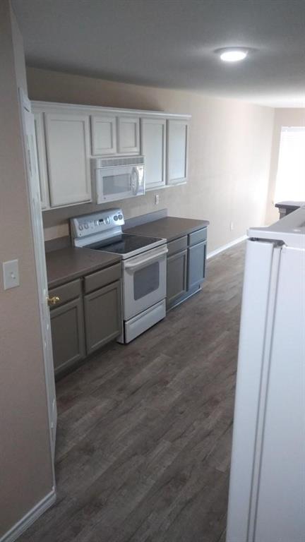 306 Packer Drive Fate, TX 75189 - Photo 4 of 15 a kitchen with a sink and a refrigerator