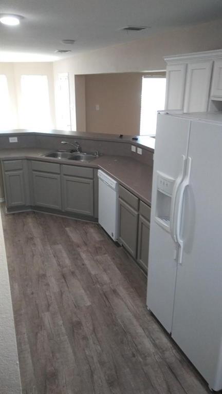 306 Packer Drive Fate, TX 75189 - Photo 5 of 15 a kitchen with stainless steel appliances a refrigerator sink and cabinets