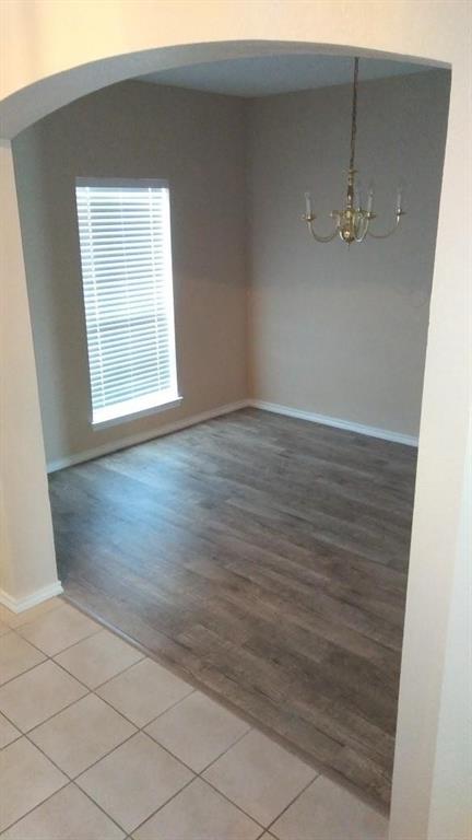 306 Packer Drive Fate, TX 75189 - Photo 7 of 15 an empty room with wooden floor and windows