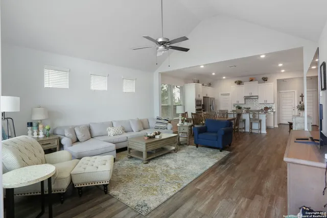 a living room with furniture kitchen view and a table