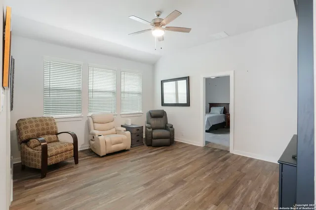 a bedroom with furniture and a large window