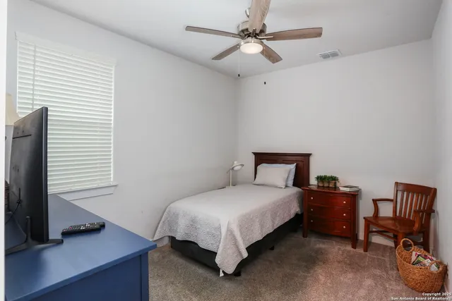 a bedroom with a bed and a desk