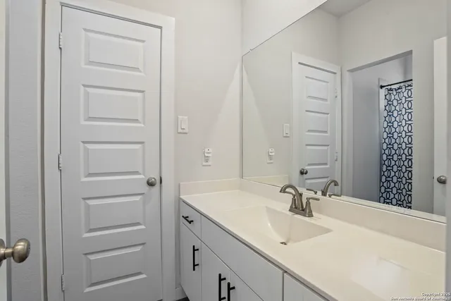 a bathroom with a sink and a mirror