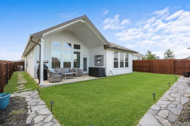 a view of a house with a yard porch and sitting area