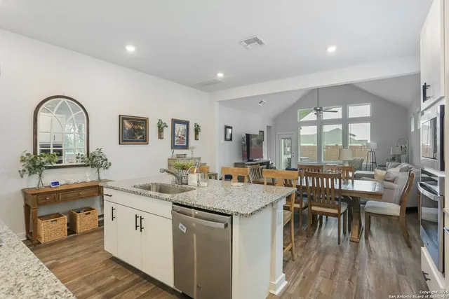 a view of a kitchen with a table and chairs
