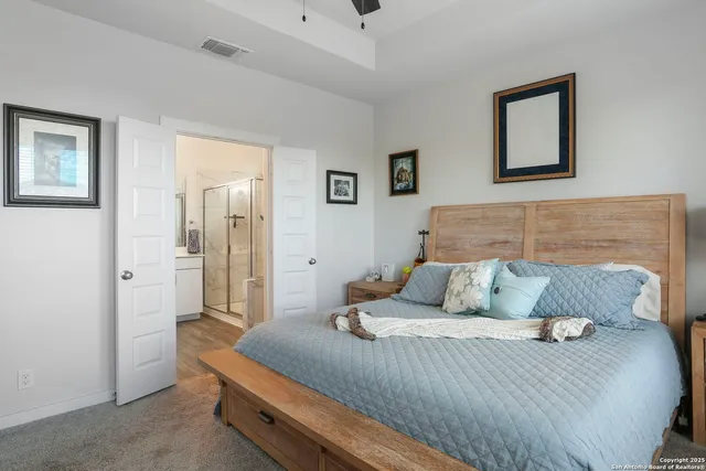 a bedroom with a bed and painting on the wall