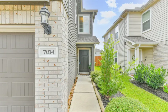 a view of entrance of the house with potted plants