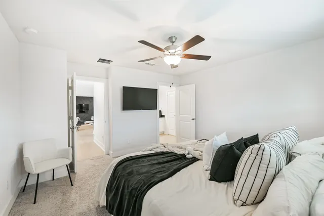 a bedroom with a bed and a chair