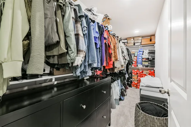 a view of walk in closet with clothes
