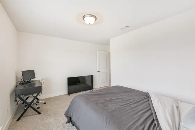 a bedroom with a bed and a chair