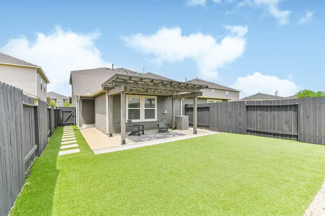 a view of a house with backyard porch and sitting area