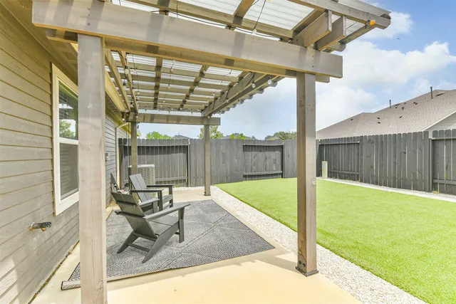 a view of a backyard with plants and patio
