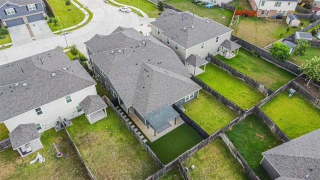an aerial view of a house with a garden and swimming pool