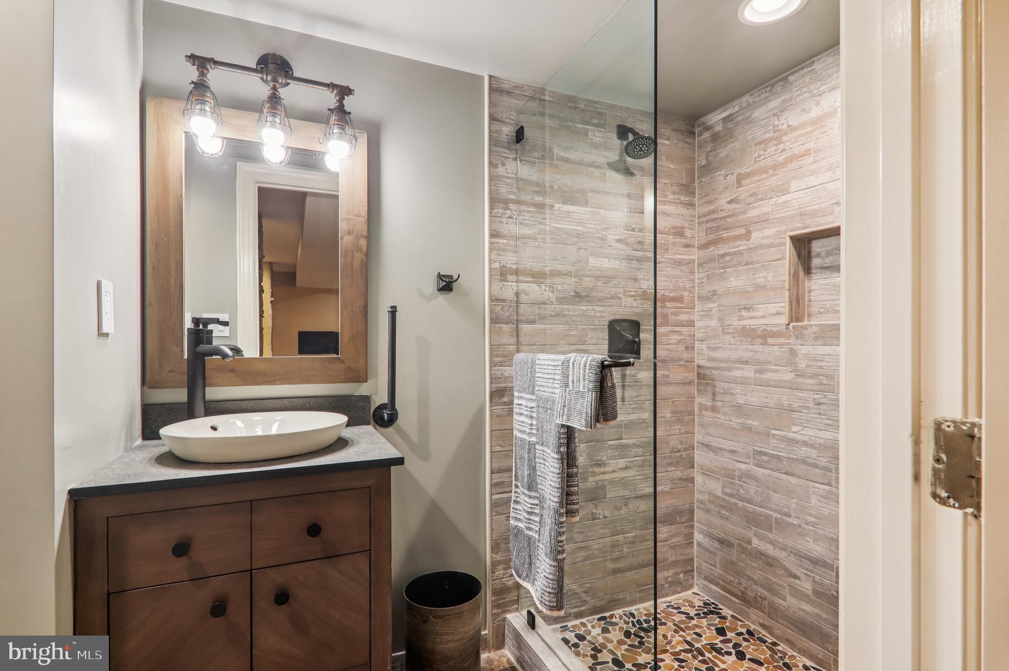 4200 19th Street Northeast Washington, DC 20018 - Photo 30 of 34 a bathroom with a sink a toilet and shower