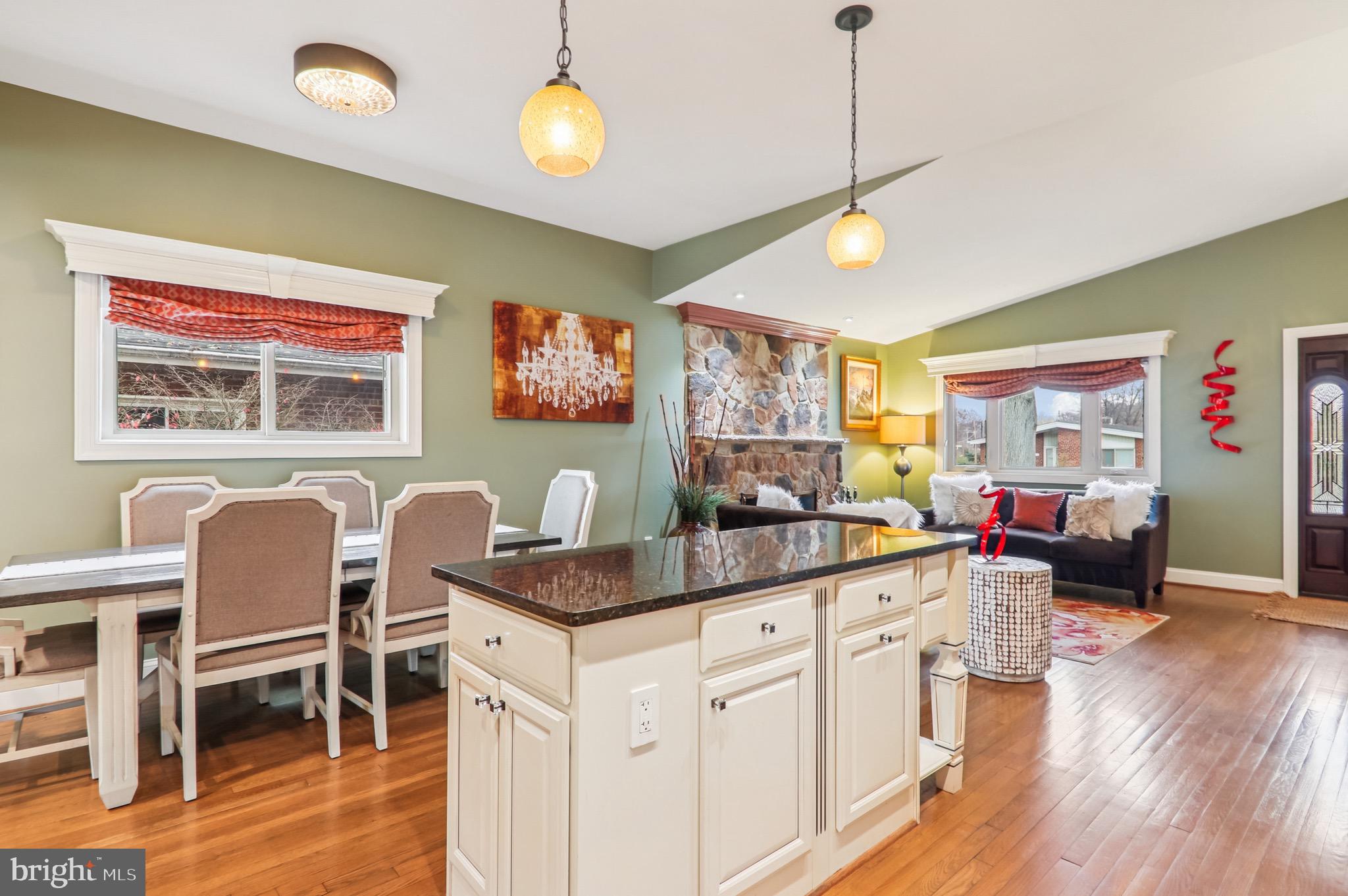 4200 19th Street Northeast Washington, DC 20018 - Photo 9 of 34 a kitchen that has a cabinets counter space dining table and a wooden floor