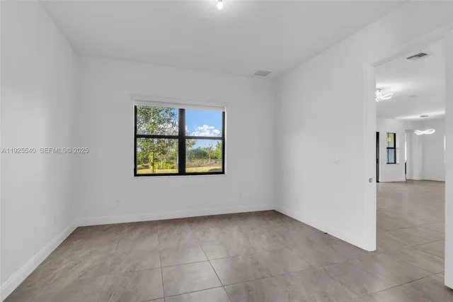 an empty room with windows and entrance