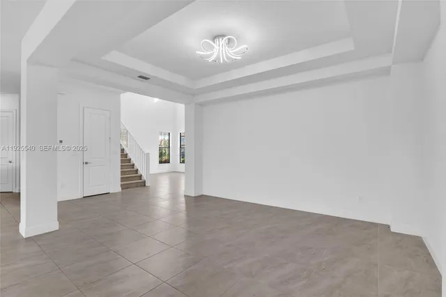 a view of an empty room with closet and a window