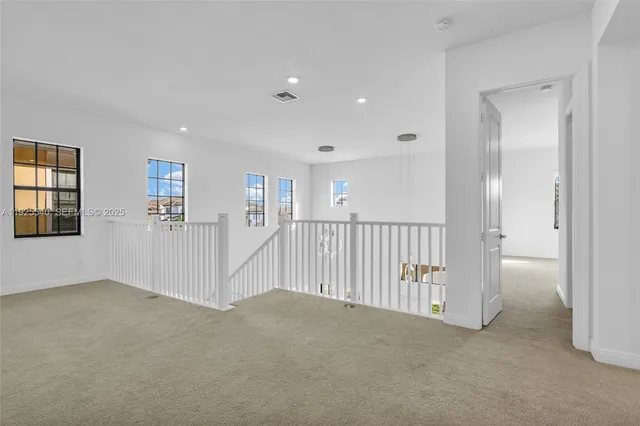 an empty room with windows and pillars in it