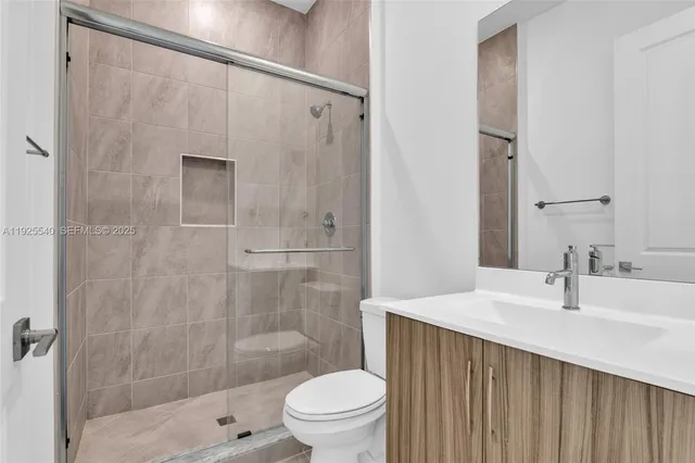 an empty room with windows and ceiling fan