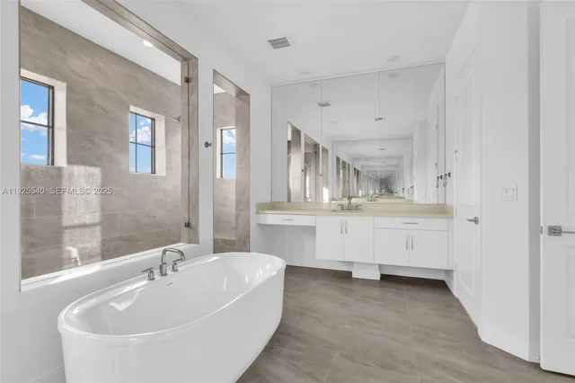 a bathroom with a glass shower door