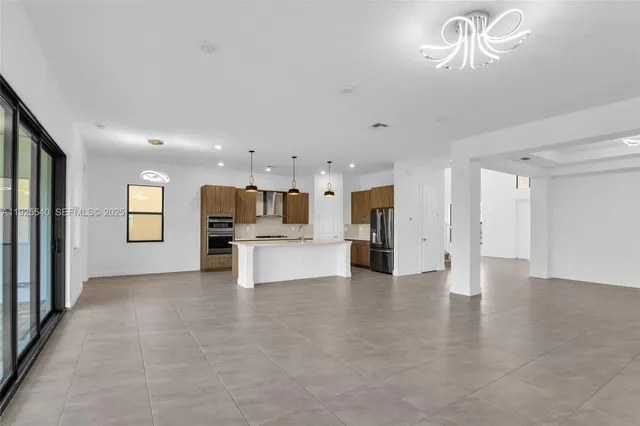 a view of kitchen with a refrigerator and a couch