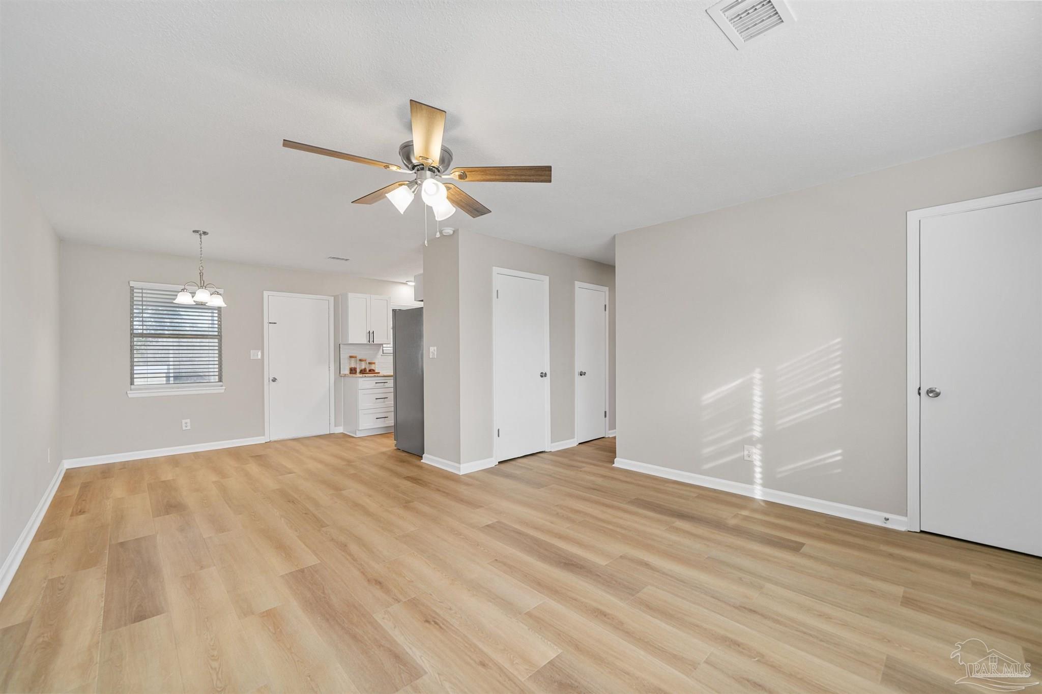 284 Dolan Drive Cantonment, FL 32533 - Photo 12 of 32 a view of an empty room with a chandelier fan