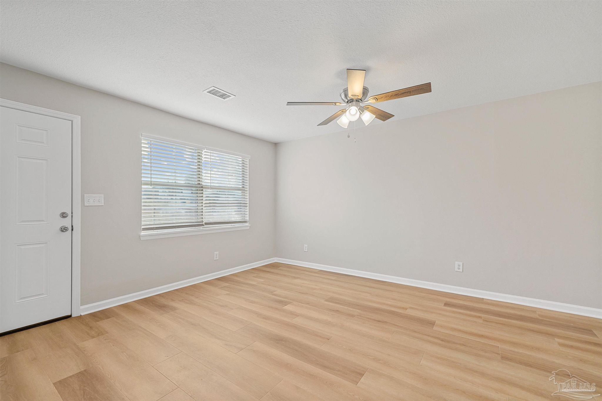 284 Dolan Drive Cantonment, FL 32533 - Photo 15 of 32 wooden floor in an empty room with a window