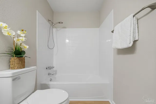 a bathroom with a toilet and a shower