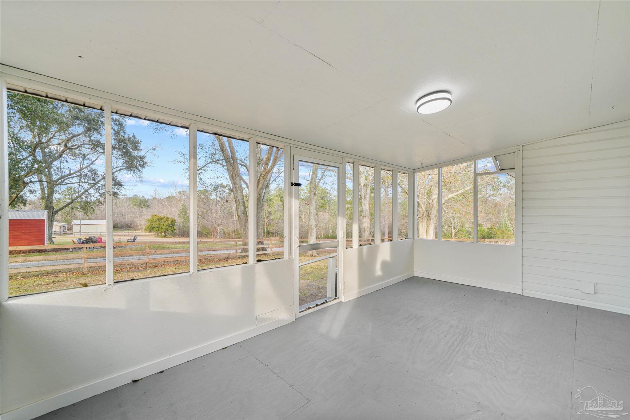 284 Dolan Drive Cantonment, FL 32533 - Photo 29 of 32 an empty room with wooden floor and windows