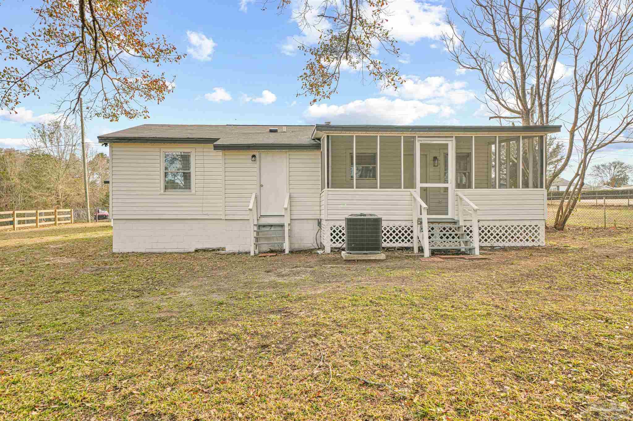 284 Dolan Drive Cantonment, FL 32533 - Photo 31 of 32 a front view of a house with a yard and garage