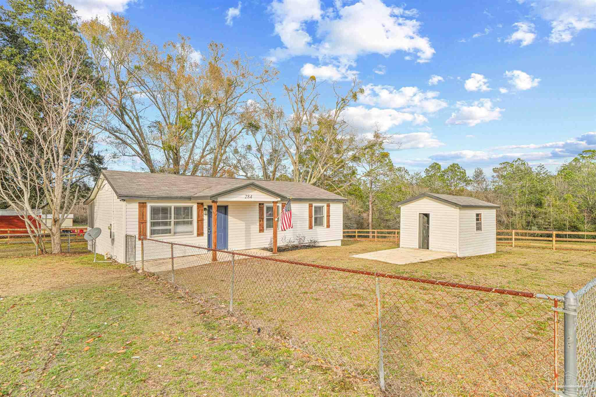 284 Dolan Drive Cantonment, FL 32533 - Photo 6 of 32 a front view of house with yard and trees around