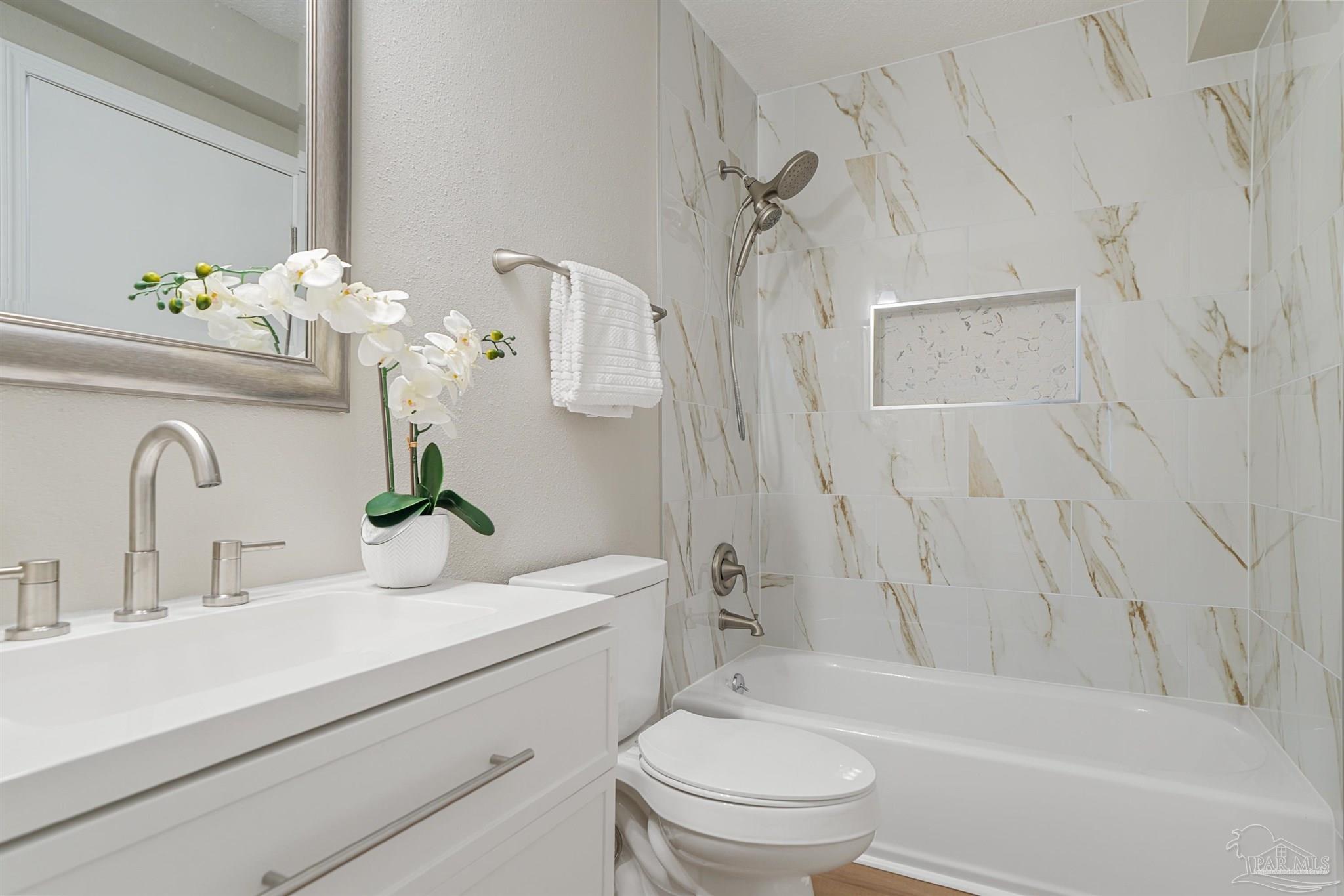 284 Dolan Drive Cantonment, FL 32533 - Photo 9 of 32 a bathroom with a sink a toilet and a bathtub