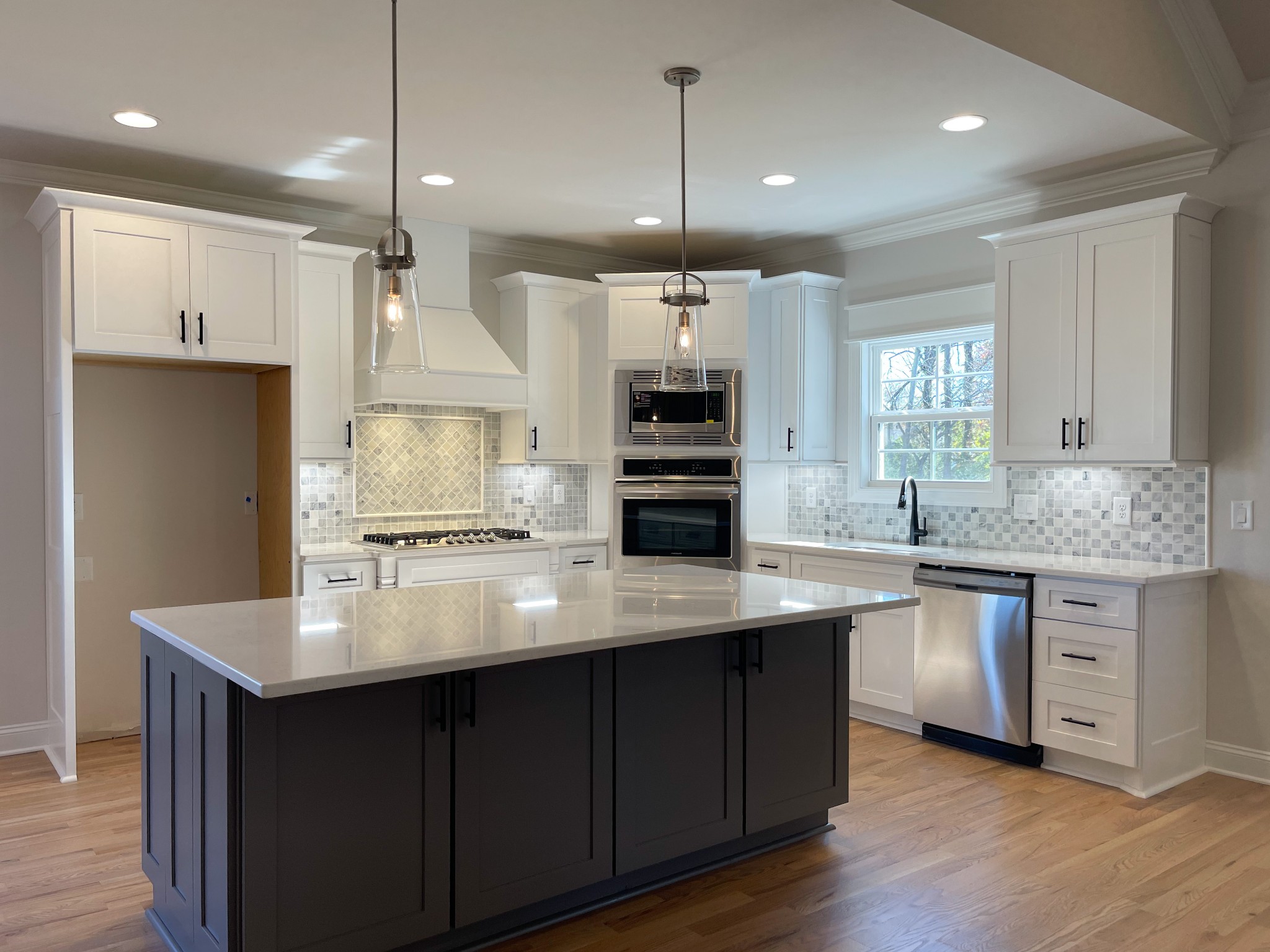 3035 Turnstone Trace Spring Hill, TN 37174 - Photo 13 of 41 a kitchen with kitchen island granite countertop a sink cabinets and wooden floor