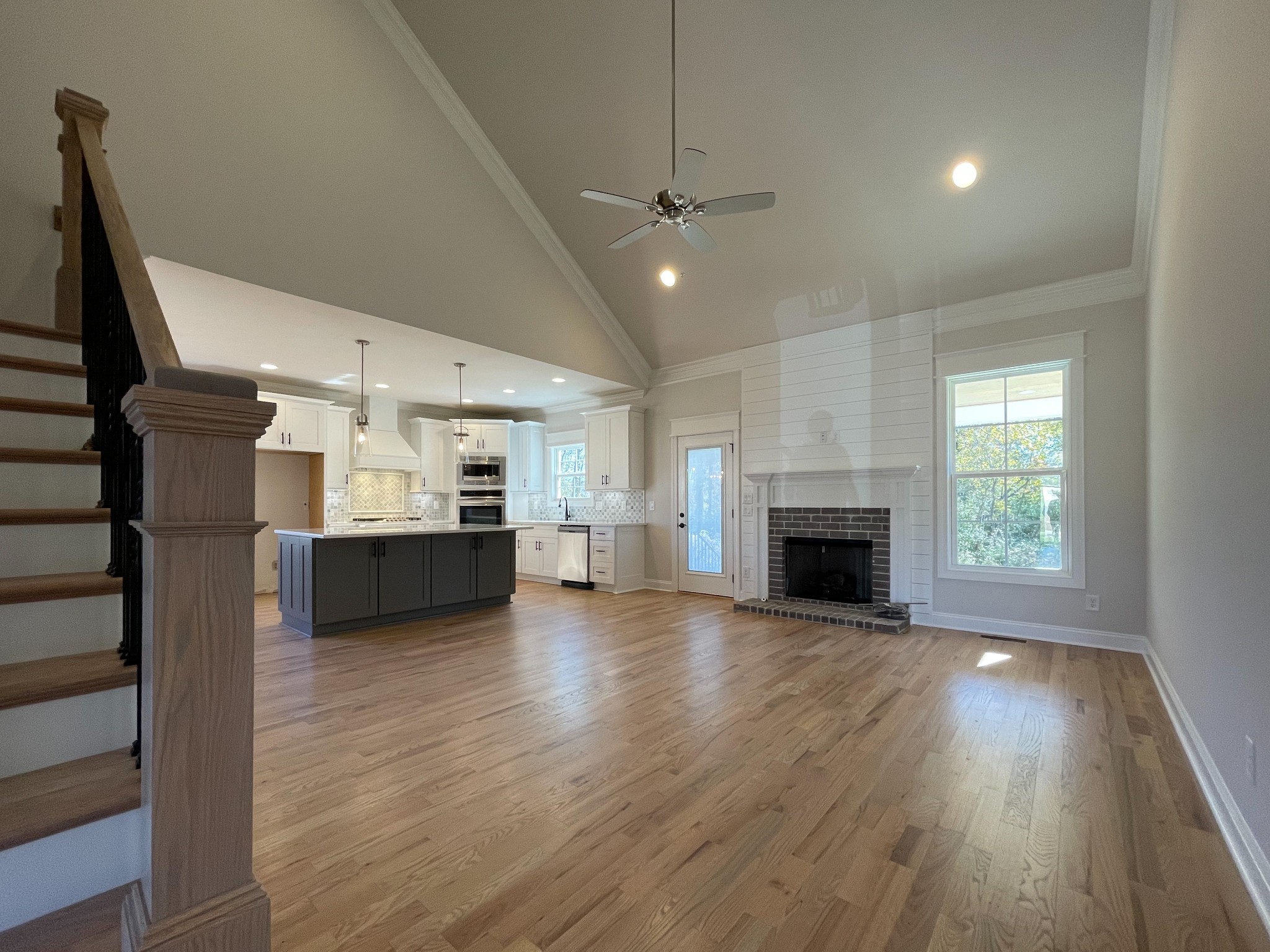 3035 Turnstone Trace Spring Hill, TN 37174 - Photo 28 of 41 a view of a kitchen and an empty room with wooden floor