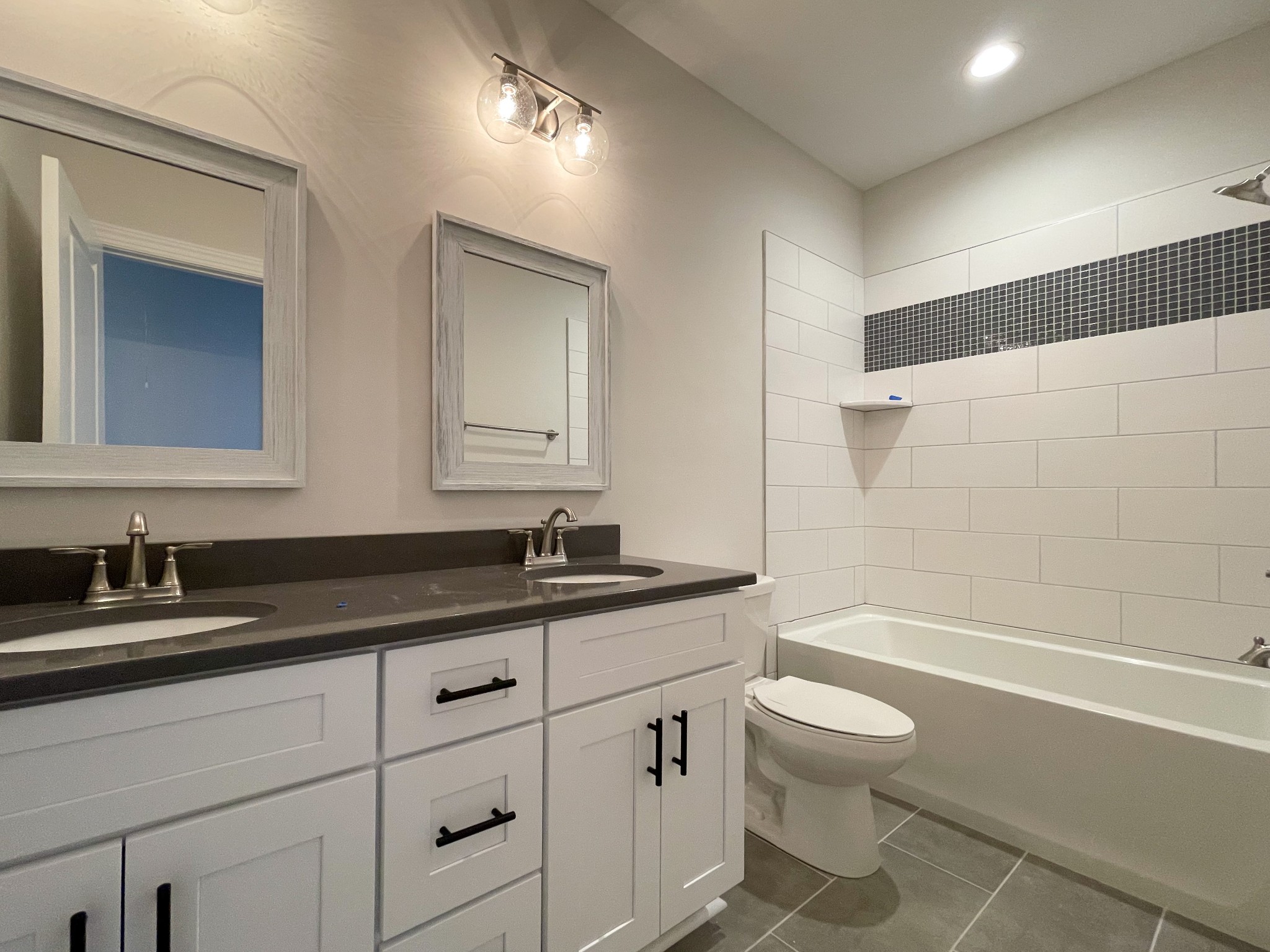 3035 Turnstone Trace Spring Hill, TN 37174 - Photo 32 of 41 a bathroom with a granite countertop sink a toilet a mirror and bathtub